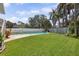 Well-maintained backyard with an in-ground pool and fountain feature at 1842 Bayou Grande Ne Blvd, St Petersburg, FL 33703