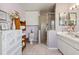 Bathroom offering a glass door shower, commode, vanity, and linen storage at 1842 Bayou Grande Ne Blvd, St Petersburg, FL 33703