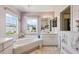 Bathroom featuring a soaking tub, vanity, and natural light from two windows at 1842 Bayou Grande Ne Blvd, St Petersburg, FL 33703