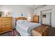 Bedroom with a bed, ceiling fan, dressers, and an open doorway at 1842 Bayou Grande Ne Blvd, St Petersburg, FL 33703