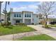 Charming two-story home featuring a well-kept lawn, mature landscaping, and a spacious driveway at 1842 Bayou Grande Ne Blvd, St Petersburg, FL 33703