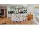 Kitchen with white cabinets, black countertops, and adjacent breakfast bar seating at 1842 Bayou Grande Ne Blvd, St Petersburg, FL 33703