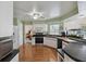 Open kitchen featuring white cabinets, black counters, and stainless steel appliances at 1842 Bayou Grande Ne Blvd, St Petersburg, FL 33703