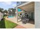 Covered patio next to a swimming pool and tropical landscaping at 1842 Bayou Grande Ne Blvd, St Petersburg, FL 33703