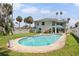 Backyard view of the pool at this two-story home with stairs leading to the second story outdoor deck at 1842 Bayou Grande Ne Blvd, St Petersburg, FL 33703
