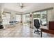 Bright sunroom with tile flooring, sliding glass doors, and views of the backyard pool at 1842 Bayou Grande Ne Blvd, St Petersburg, FL 33703