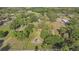 Expansive lot with mature trees and multiple structures, providing ample space and privacy at 18838 Huckavalle Rd, Odessa, FL 33556