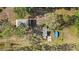 Detailed aerial view showing a home with an above-ground pool and mature, established trees at 18838 Huckavalle Rd, Odessa, FL 33556