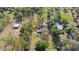 Aerial view of a property with multiple structures, lush trees, and well-maintained landscaping at 18838 Huckavalle Rd, Odessa, FL 33556