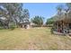 Spacious backyard featuring a cozy seating area and covered outdoor space, perfect for entertaining at 18838 Huckavalle Rd, Odessa, FL 33556