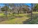 Expansive backyard featuring an above-ground pool, covered outdoor area, and ample space for relaxation and recreation at 18838 Huckavalle Rd, Odessa, FL 33556