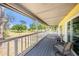Relaxing outdoor balcony with seating, offering a scenic view of the lush green surroundings at 18838 Huckavalle Rd, Odessa, FL 33556