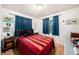 Cozy bedroom with natural light, a comfortable bed, and charming decor at 18838 Huckavalle Rd, Odessa, FL 33556