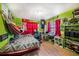 Unique bedroom with colorful decor, fun accents, and a comfortable bed and hammock at 18838 Huckavalle Rd, Odessa, FL 33556