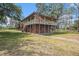 Charming two-story home with a wraparound porch and brick foundation at 18838 Huckavalle Rd, Odessa, FL 33556