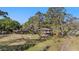 Charming two-story home featuring a brick foundation and a covered balcony, all under the shade of mature trees at 18838 Huckavalle Rd, Odessa, FL 33556