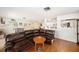 Spacious living room featuring hardwood floors, a large sectional, and ample lighting at 18838 Huckavalle Rd, Odessa, FL 33556