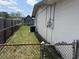 Shot of the side yard and the back of the house with AC unit at 1905 Meridel Ave, Tampa, FL 33612