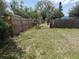 Wide shot of the grass backyard area with a chainlink and wood fence surrounding the perimeter at 1905 Meridel Ave, Tampa, FL 33612