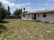Spacious backyard featuring sparse grass, a wooden fence, and the rear of the home at 1905 Meridel Ave, Tampa, FL 33612