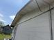 Angled view of home's exterior showing the siding, roofline, and utility wiring at 1905 Meridel Ave, Tampa, FL 33612