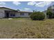 Close up of a home with overgrown lawn on a sunny day with a few clouds at 1905 Meridel Ave, Tampa, FL 33612
