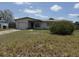 Exterior shot of a home with a garage and lawn in need of maintenance at 1905 Meridel Ave, Tampa, FL 33612