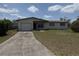 Exterior shot of a house with an attached garage and a concrete driveway at 1905 Meridel Ave, Tampa, FL 33612