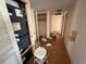 Hallway with open door shows the flooring, and the closet holds the HVAC system at 1905 Meridel Ave, Tampa, FL 33612