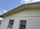 View of eaves and roofline of home exterior showing beige and brown features at 1905 Meridel Ave, Tampa, FL 33612