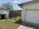 View of the side yard and garage with a privacy fence at 1905 Meridel Ave, Tampa, FL 33612
