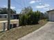 View of side yard with two cut logs on the side of the driveway at 1905 Meridel Ave, Tampa, FL 33612