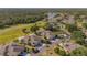 Beautiful aerial view of a residential neighborhood with lush greenery, a golf course, and a lake at 2007 Acadia Greens Dr # 0, Sun City Center, FL 33573