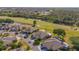 Aerial view of homes with golf course in the background, showcasing location and community setting at 2007 Acadia Greens Dr # 0, Sun City Center, FL 33573
