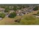Aerial view of a home with a screened porch, mature trees, and a golf course at 2007 Acadia Greens Dr # 0, Sun City Center, FL 33573