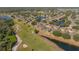Aerial view showcases backyard and golf course with mature landscaping in this beautiful community at 2007 Acadia Greens Dr # 0, Sun City Center, FL 33573