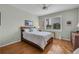 Comfortable bedroom with wood floors, neutral paint, a ceiling fan, and a large window at 2007 Acadia Greens Dr # 0, Sun City Center, FL 33573