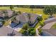 Aerial view of a well-maintained home with a two-car garage, mature landscaping, and a manicured lawn at 2007 Acadia Greens Dr # 0, Sun City Center, FL 33573