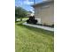 Well-maintained front yard with lush green grass and manicured landscaping surrounding the home at 2007 Acadia Greens Dr # 0, Sun City Center, FL 33573