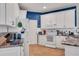Bright kitchen featuring white cabinets, granite countertops, tile flooring, and modern appliances at 2007 Acadia Greens Dr # 0, Sun City Center, FL 33573