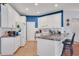 Bright kitchen with white cabinets, tile floors, granite countertops, and a breakfast bar at 2007 Acadia Greens Dr # 0, Sun City Center, FL 33573