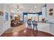 Open floor plan with a modern kitchen with breakfast bar flowing into the formal dining area at 2007 Acadia Greens Dr # 0, Sun City Center, FL 33573