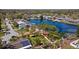 Aerial view of yellow home in a waterfront neighborhood with canal access and mature tropical landscaping at 2142 Ibis, Clearwater, FL 33764