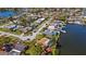 Aerial view of canal neighborhood with boat docks, pools, and well-maintained landscaping on a sunny day at 2142 Ibis, Clearwater, FL 33764