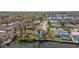 Aerial view of canal neighborhood with boat docks, single-Gathering homes, mature landscaping, and canal access at 2142 Ibis, Clearwater, FL 33764