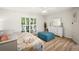 Well-lit bedroom with neutral tones, hardwood floors, and shuttered windows at 2142 Ibis, Clearwater, FL 33764