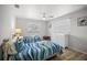 Cozy bedroom with two twin beds, light wood floors, and a ceiling fan at 2142 Ibis, Clearwater, FL 33764