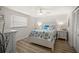 Bright bedroom featuring wood floors, a ceiling fan, and beach themed accents at 2142 Ibis, Clearwater, FL 33764