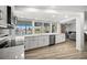 Updated kitchen with white cabinets, stainless steel appliances, and views of the pool at 2142 Ibis, Clearwater, FL 33764