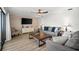 Comfortable living room with luxury vinyl plank flooring, accent wall and modern furnishings at 2142 Ibis, Clearwater, FL 33764